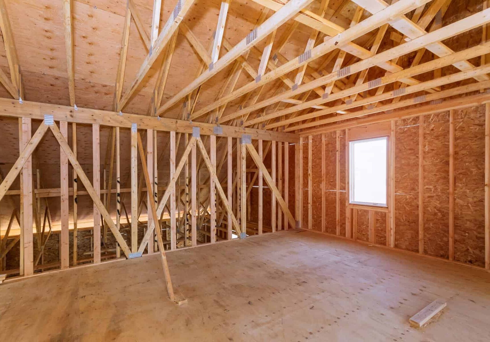 Unfinished attic of a private house residential construction house framing agains